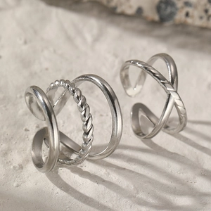Minimalist silver stainless steel rings featuring layered twist and X-cross geometric designs