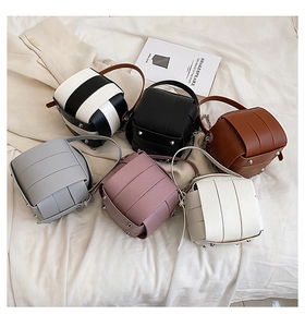 Collection of colorful woven cube mini bags with chain straps in six diverse color options