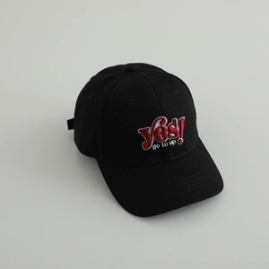 Close-up of black cotton baseball cap with red 'Yes!' and white 'go to up' embroidery