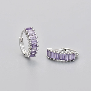 Detail view of silver hoop earrings featuring rectangular purple zircon stone inlay