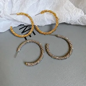 Minimalist twisted rope hoop earrings in gold and silver finish with braided texture