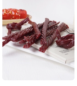 Detailed view of realistic faux twisted candy strip with glossy spiral texture and red hawthorn