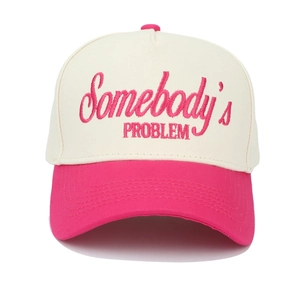 Detail of Somebody's Problem pink embroidery on a cream and pink trucker baseball cap