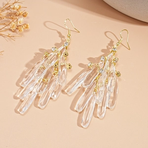 Close-up of elegant gold tassel earrings with clear crystal glass drop pendants