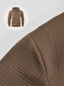 Close-up of coffee brown knit hoodie showing herringbone texture and drawstring collar