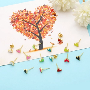 Detailed view of colorful enamel heart earrings in diverse colors on a stylized card