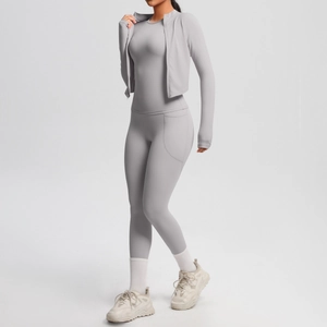 Detail view of light grey three-piece yoga set with zippered jacket and side pockets