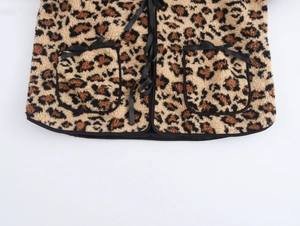 Detail showing plush leopard print texture with black ribbon bow and large side pockets
