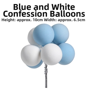 Close-up of blue and white clay balloon cake toppers on thin silver wire stems