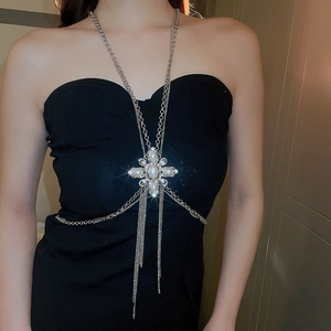 Detail of silver body chain featuring pearl rhinestone pendant and layered fringe tassels