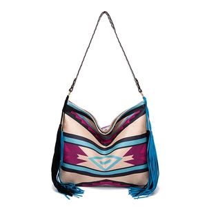 Detail view of Bohemian woven tote with geometric patterns and colorful side tassels