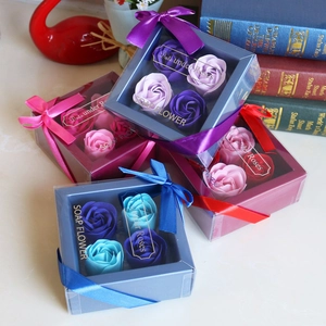 Close-up of assorted soap flower gift boxes with roses and ribbons in multiple colors