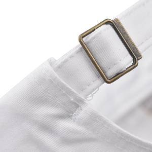 Close-up of white cotton strap and vintage bronze metal adjustment buckle on baseball cap