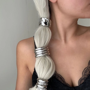 Silver minimalist metal hair rings on a braided ponytail with black lace top detail