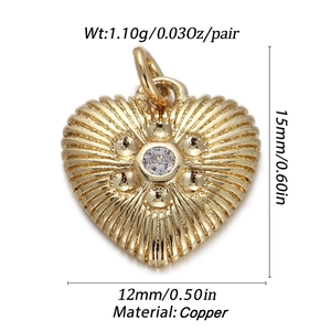 Macro shot of gold-plated copper heart charm with crystal inlay and size measurement details