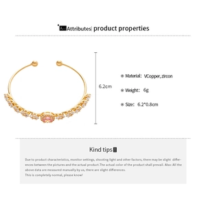 Detail showing 6.2cm gold open bangle made of copper with micro-paved clear and pink zircons