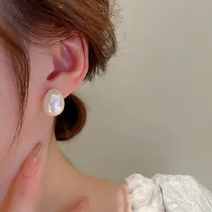 Elegant minimalist iridescent teardrop pearl stud earrings with a glossy white finish