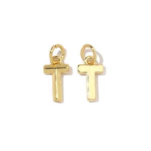 Detail of 18K gold plated cross pendants with zirconia stones on a white background