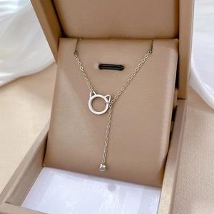 Minimalist silver cat pendant necklace with tassel bead displayed in a jewelry gift box