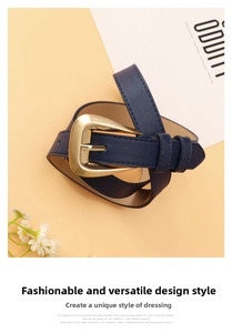 Detail of navy blue faux leather belt with matte gold buckle and lychee texture