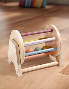 Macro shot of spinning wooden drum toy with colorful bars for sensory development