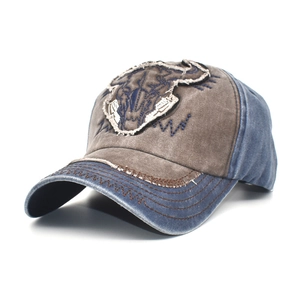 Detailed close-up of vintage washed cotton baseball cap with cow skull embroidery