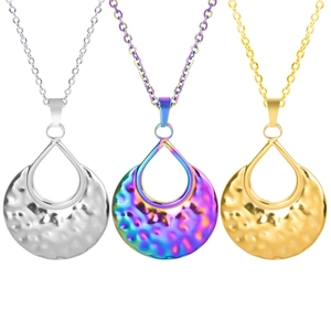 Close-up of three hammered metal teardrop pendants in gold, silver, and rainbow finishes