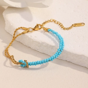 Detailed macro view of 18K gold twist chain and blue natural stone bracelet detail