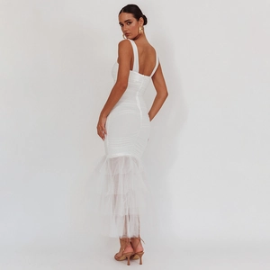 Detail of elegant white mermaid dress featuring ruffled back and layered mesh tulle hemline