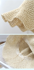 Detail of woven straw hat featuring inner adjustable drawstring and wavy brim texture