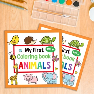 Kids coloring book with cartoon animals and creative art supplies on wood desk
