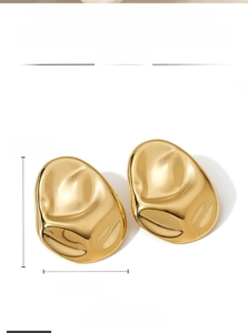 Detail of chunky gold molten lava earrings showing 47mm height and 36mm width dimensions