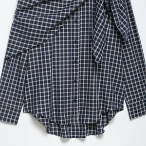 Navy blue and cream plaid long sleeve shirt featuring asymmetrical layered draped hemline