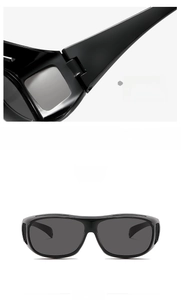 Detail of solid hinge and front view of black frame cycling sunglasses with grey lenses