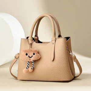 Fashionable beige lychee pattern leather tote bag with a cute brown cloud plush charm