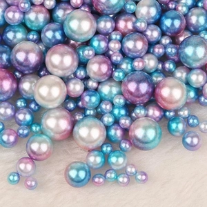 Macro detail of iridescent blue-purple gradient faux pearls on soft white plush fabric