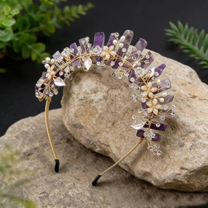 Detailed macro view of handmade gold crown headband with purple crystals and pearl flowers