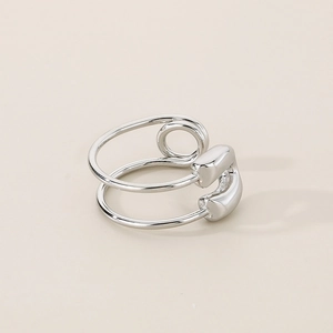 Close-up of double-layered open ring with creative safety pin spiral design