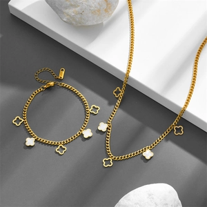 Gold stainless steel jewelry set with clover pendants including a necklace and bracelet