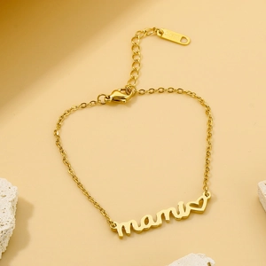 Detail of gold mami letter bracelet with heart charm and secure lobster clasp closure