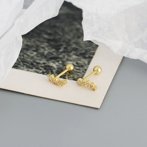 Macro shot of gold S925 sterling silver screw back earrings with five zircon stones