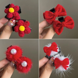 Detail of red Christmas hair clips featuring velvet flowers, sequins, and pearls
