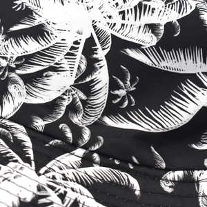 Macro shot of tropical palm leaf print and double-stitched seam on a sun hat