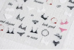Detailed view of 5D thin nail stickers featuring delicate lace lingerie and red heart patterns