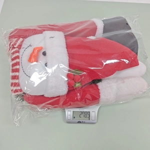 Detailed view of plush Christmas tree topper decoration weighing 218.5g on a scale