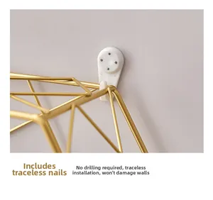 Detail of Nordic golden metal wall shelf with white non-marking nail for easy installation