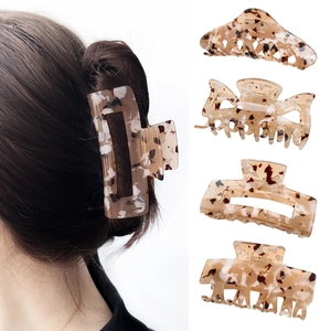 Set of four tortoiseshell hair claw clips in amber patterns and model wearing square clip