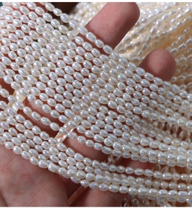 Close-up of 4mm high-luster white freshwater rice pearls strands for DIY jewelry making