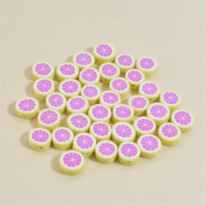 Top view of 10mm yellow polymer clay beads with pink lemon slices for DIY jewelry crafts