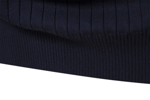 Macro shot of high-quality navy blue ribbed knit fabric showing dense textile texture